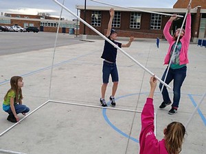 members of the middle school team cutting PVC pipe for the set of their play