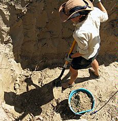 USU grad student digging study trench