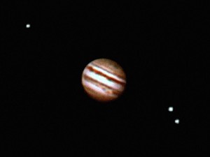 The planet Jupiter and moons in the night sky