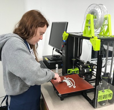 USU Eastern LLC Student employee, Holly Fellmeth, making a face shield.