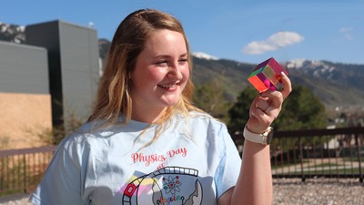 Physicist holding CMY cube.