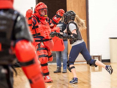 woman attacking assailant in simulation