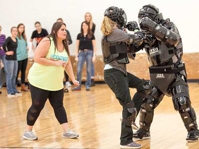 woman encourages simulation victim to attack aggressor