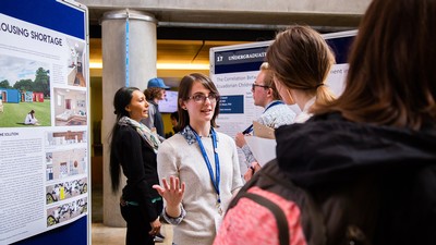 student presenting research at an event.