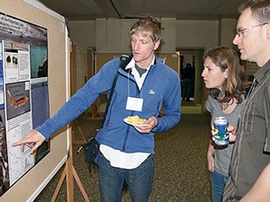 a student doing a poster presentation at a conference