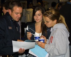 Student with Aggie Ice Cream get information