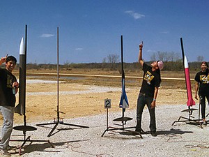 Three members of the USU Eastern Engineering Team with rockets