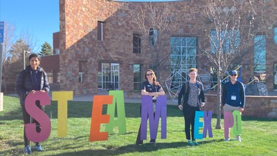 Students stand on a lawn