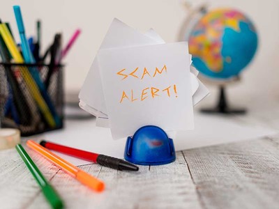 scams graphic with calculator on a table.