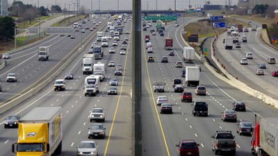 large highway with vehicles driving.
