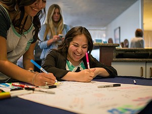 Students in the Aggie Smart Start Scholarship Program sign a thank-you card for Pepsi