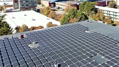 Solar panels line a parking terrace rooftop.