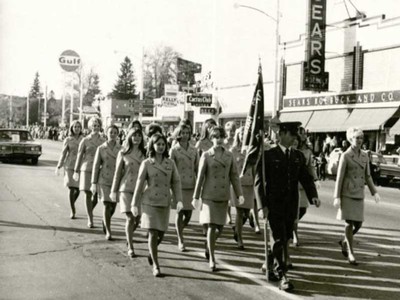Angel Flight members marching in a parade on Main Street