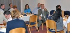 President Albrecht (center) listens during the breakfast meeting