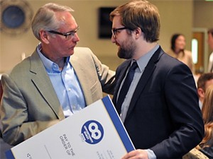 presenting an oversized check at the entrepreneur competition