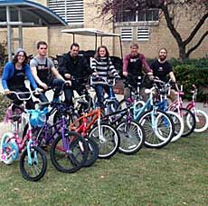 Aggie Blue Bikes and volunteers with bicycles for Sub for Santa