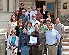 USU History Department faculty on steps of Old Main with award