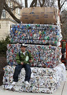 Albert Bergado atop recycled material at USU