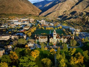 an aerial view of the Utah State University campus and Old Main in the fall