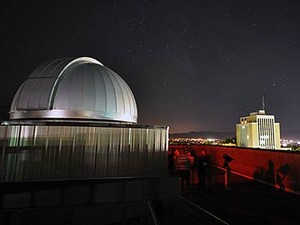 a nightime view of the USU Observatory and the business building