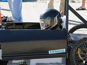 a race car and driver competing in the Greenpower Invitation
