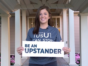 USU student Felicia Gallegos holding Updstander poster
