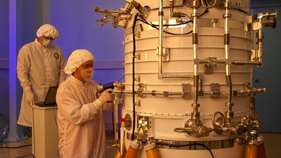 engineers from the Space Dynamics Laboratory working on the WISE telescope at SDL.