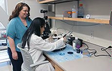 USU faculty member Abby Benninghoff in lab with graduate student