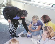 A museum professional with children in a hands-on activity