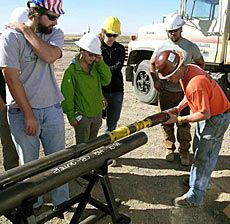 USU grad students with drillers at project site