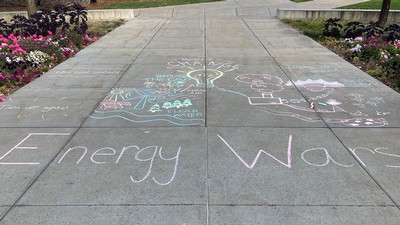 Energy Wars written in chalk on a USU sidewalk.