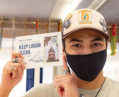 USU student holding a sign saying