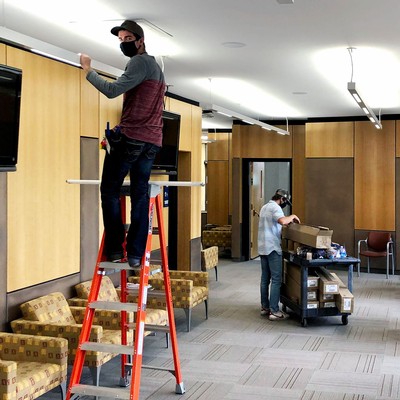 USU facilities employees installing lights on campus.