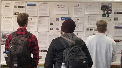 students look at job postings at the QCNR job fair.