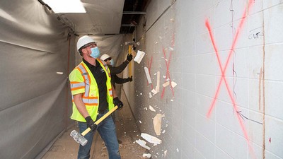 USU alum and J-U-B project engineer Colton Smith participates in the Mar. 25 demolition.