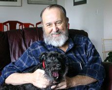 Ken Brewer at home with his dog