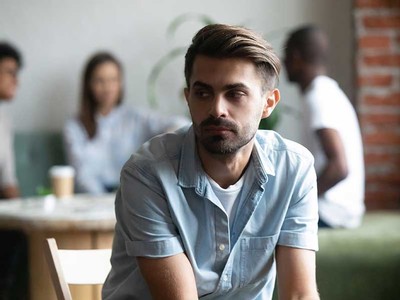 man sitting apart from others