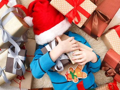 child with a pile of presents
