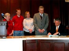 Jack Draxler and family watch bill signing