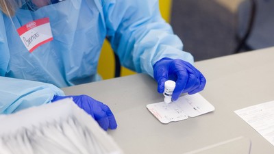 Lab employee conducting a COVID-19 test.