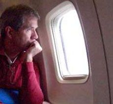 passenger looking out plane window
