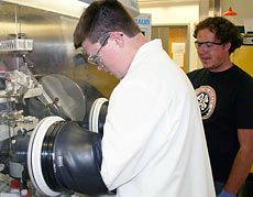 high school students using a glove box at USU workshop