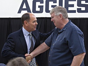 USU's new head men's basketball coach is congratulated by former coach Stew Morrill