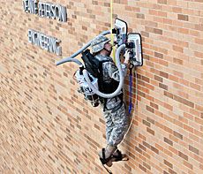 A USU ROTC student climbing a wall during a demonstration