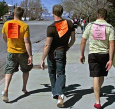 Men walking in the Walk-a-Mile-in-Her Shoes fundraising event