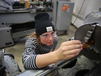 USU student working with a lathe