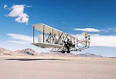 The modern replica of the Wright Flyer takes off