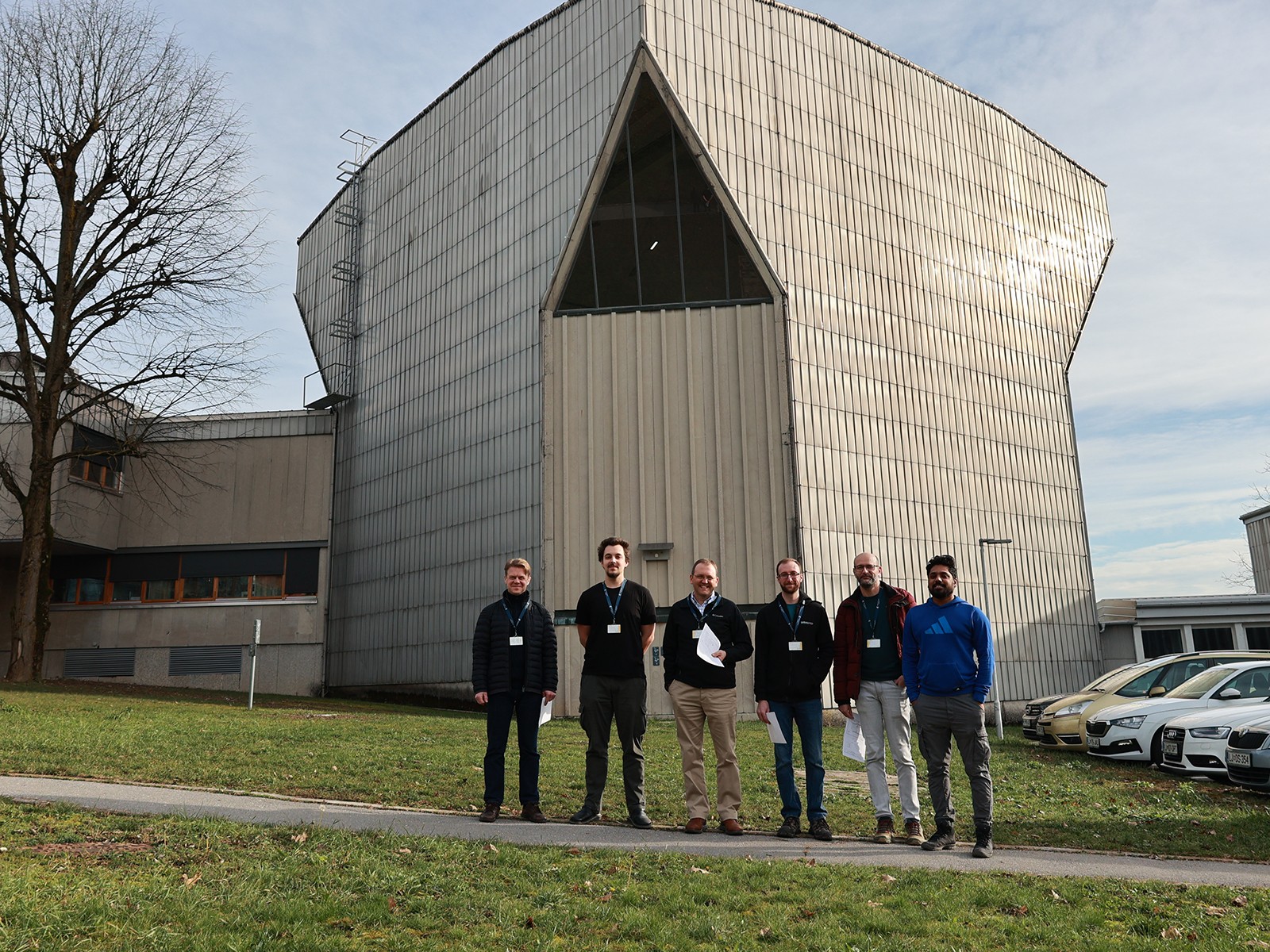 Scientists gather to pose for a photograph outside a facility