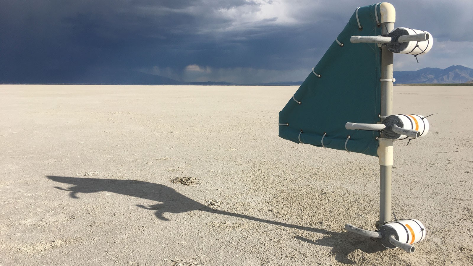 A monitoring station stands in the dry lakebed of the Great Salt Lake.