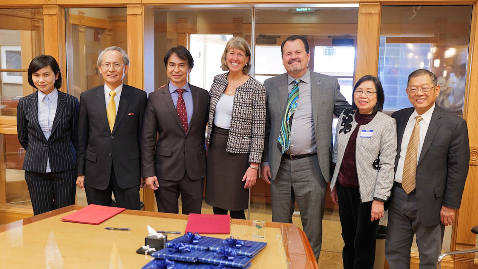 Officials pose for a photograph in USU's Old Main building in Logan.